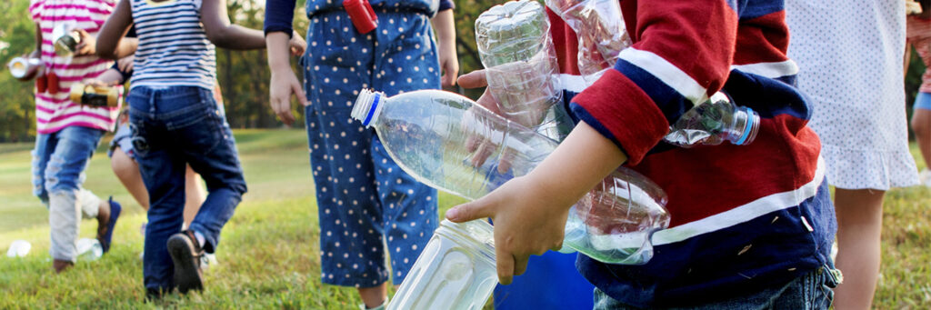 Child holding empty plastic bottle